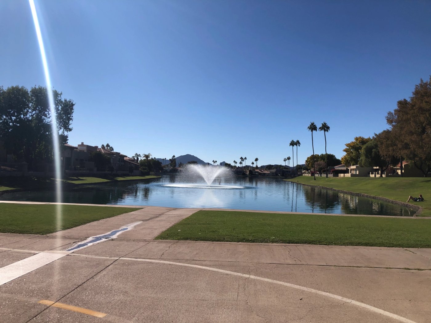 Lake fountain with grassy banks along the Scottsdale greenbelt